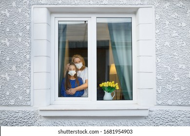 Quarantine window home for mother and daughter - Shutterstock ID 1681954903