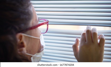 Quarantine Of Woman Infected With Corona Virus, 2019-Ncov Or Covid-19. Novel Coronavirus. Isolation In Hospital, Female Look Out Of Window Blinds