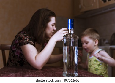 Quarrel Between Drunk Mother And Her Little Son. Alcoholic Addiction. Family Problems, Female Alcoholism. Focus On Bottle.