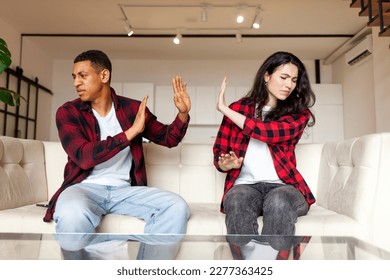 quarrel in multiracial family, young couple relationship problems, african american man does not want to talk to girlfriend, sad unhappy couple after scandal sitting on sofa at home - Shutterstock ID 2277363425