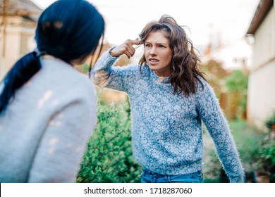 Quarrel Two Friends. Two Women Screaming At Each Other. Two Young Women Argue. Family Problem. Angry. Female. Nature Background. Emotional. Emotion. Depression. People. Stress. Family Photo. 
