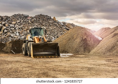Quarry aggregate with heavy duty machinery. Construction industry.