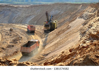 Quarry excavator loading sand or into dump truck at opencast. Excavation of mineral resources, the work of special mining equipment - Image