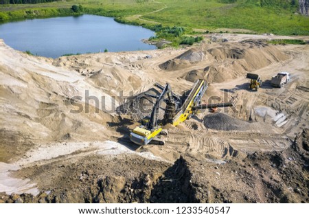Quarry stone crushing machine at work.
