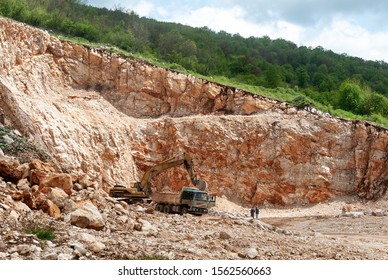 Quarry And Quarry Workers On Stone Driller