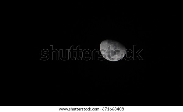 Quarter moon in dark black
background