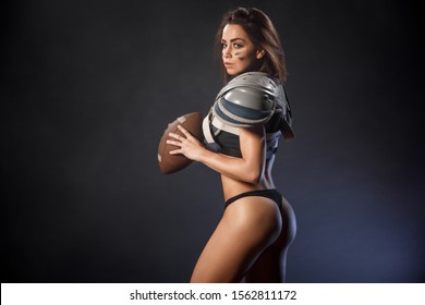 Quarterback girl with ball in smoke