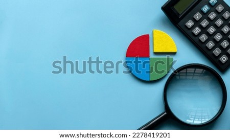 Quarterly report concept. Company financial report. Business charts. Colorful quarter wooden pie chart pieces with calculator. Banner with copy space.