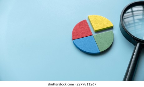 Quarterly report concept.Company financial report.Business charts. Colorful quarter wooden pie chart pieces. Banner with copy space.