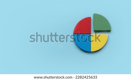 Quarterly report concept.Company financial report.Business charts. Colorful quarter wooden pie chart pieces. Banner with copy space.