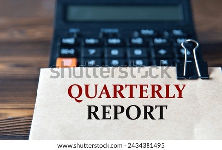 QUARTERLY REPORT - words on light brown paper on calculator background