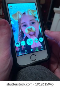 Quebec, Canada - 02-08-2021: A Little Girl Has Fun With The Dog Face App With Snapchat