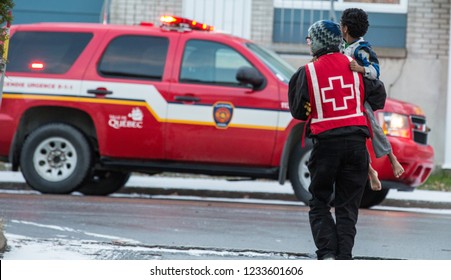 Quebec, Canada - February 2015 - Red Cross Volunteer Help Kid After House Fire.