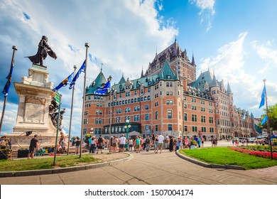 Quebec, Canada - July 29, ‎2018: Tourists and locals looking at entertaining show at Dufferin Terrace in front of Samuel de Champlain monument close to the iconic Chateau Frontenac in Old Quebec City.