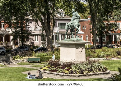 Quebec City 13.09.2017: Bronze Statue Of Sancta Joanna D Arc - Joan Of Arc Stands As A War Memorial In A Colorful Garden On A Sunny Day