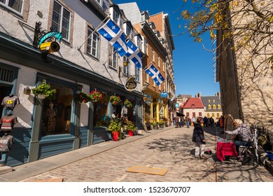Quebec City, Canada - 5 October 2019: Quebec flags on Notre-Dame street.