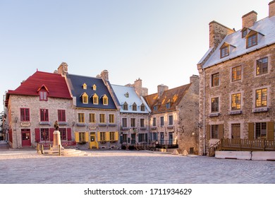 Quebec City, Quebec, Canada, April 23, 2020- View of the Louis XIV statue and patrimonial buildings on the 17th Century Place Royale in the Petit-Champlain sector during a sunny morning