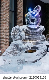 Quebec City, Quebec Canada, February 7 - Life-size Ice Sculpture Of Man Next To A Pile Of Giant Bagels In Front Of Store On Maguire Street To Highlight The Winter Festival