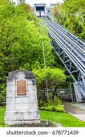 Quebec City, Canada - May 30, 2017: Lower Old Town With View Of Funiculaire And Memorial Sign For Louis Jolliet