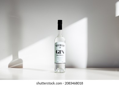 Quebec City, Quebec, Canada, November 30, 2021 - Bottle Of Small Batch Montreal Produced Rosemont Gin Set In Rays Of Light On Plain Cream Background