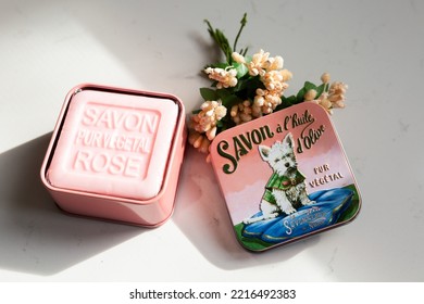 Quebec City, Quebec, Canada, October 20, 2022 - Pure Olive Oil And Essence Of Rose Square Soap From French Producer La Savonnerie De Nyons In Cute Open Metal Box With Image Of White Dog