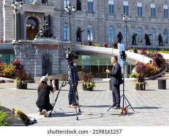 Quebec City, Quebec, Canada, September 1, 2022- Commentator Being Interviewed By News Anchor Bruno Savard For Television In Front Of The Parlement During The Provincial Election Campaign