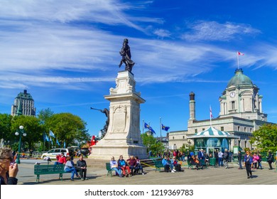 Quebec City, Canada - September 27, 2018: Scene of the Dufferin Terrace and the Armes square (Place dArmes) with locals and visitors, in Quebec City, Quebec, Canada