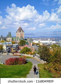 Quebec City, Quebec - October 12th, 2013: A Young Tourist Begins Her Walk To The Fairmont Le Château Frontenac And The Boardwalk Along The St. Lawrence River