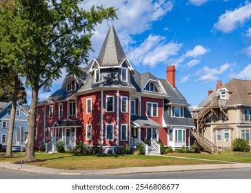 Queen Anne-style family house with dormer windows and ornate turret in Brighton, Massachusetts, USA - Powered by Shutterstock