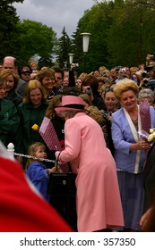 Queen Elizabeth II Accepts Flowers From A Small Child During The Royal Visit To Edmonton, Alberta, Canada, May 24, 2005.