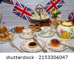Queen Elizabeth II Platinum Jubilee cream tea street party food red white and blue flags with celebration Union jack food twhite vintage table cloth with Union jack flags king charles  coronation