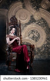 Queen In Red Dress Sitting On Throne. Symbol Of Power