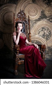 Queen In Red Dress Sitting On Throne. Symbol Of Power