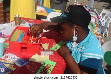 Queens, New York United States - July 10 2022: Black Boy Doing Arts And Crafts Outdoors At 5dMedia Family Literacy Event In Cambria Heights Neighborhood