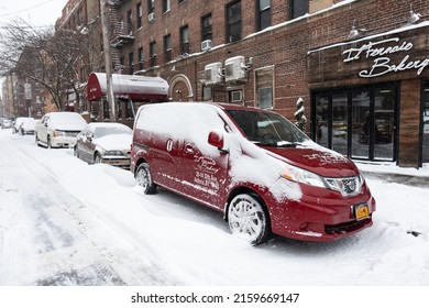 Queens, New York USA - January 29 2022: Parked Cars Along A Snow Covered Street And Sidewalk In Astoria Queens New York During The Winter