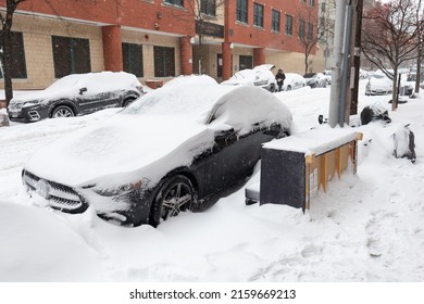 Queens, New York USA - January 29 2022: Parked Cars Along A Snow Covered Street And Sidewalk In Astoria Queens New York During The Winter