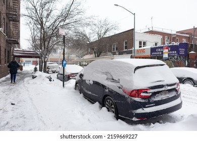 Queens, New York USA - January 29 2022: Parked Cars Along A Snow Covered Street And Sidewalk In Astoria Queens New York During The Winter