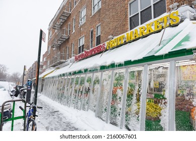 Queens, New York USA - January 29 2022: Snow Covered Grocery Store Along A Sidewalk In Astoria Queens New York During The Winter