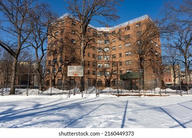 Queens, New York USA - January 30 2022: Empty Snow Covered Basketball Court Next To Public Housing In Astoria Queens New York