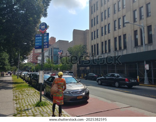 Queens, New York,\
USA - July 28, 2021: View of a bus stop and streetscape of Jamaica\
Avenue in downtown\
Jamaica