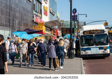 Queens, New York USA - May 17 2021: Crowded Sidewalk With People In Flushing Queens New York With A Bus Along The Street