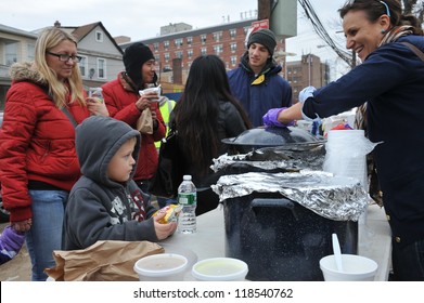 QUEENS, NY - NOVEMBER 11: People Getting Help With Hot Food, Clothes And Supplies In The Rockaway Beach Area Due To Impact From Hurricane Sandy In Queens, New York, U.S., On November 11, 2012.