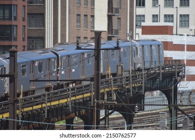 Queens, NY  USA - April 21, 2022: New York City, Elevated Subway Line and Train Traveling Through Long Island City Headed to Manhattan