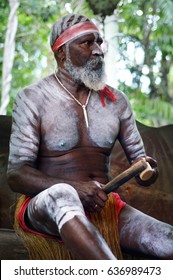 QUEENSLAND, AUS - APR 17 2016: Australian Aboriginal Man Play Aboriginal Music With Clapstick, Percussion Musical Instrument Made Out Of Wood In Queensland, Australia.