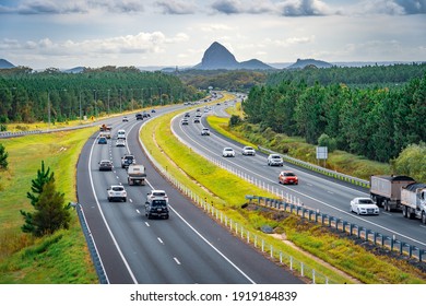 Queensland, Australia - Feb 5, 2021: Cars moving along Bruce Hwy with Glass House mountains in the background