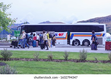 Queenstown, New Zealand 30 January 2020: Asian Tour Group Boarding A Bus At Queenstown Airport