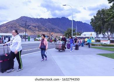 Queenstown, New Zealand 30 January 2020: Asian Tour Group Boarding A Bus At Queenstown Airport