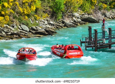 QUEENSTOWN, NEW ZEALAND - November 18: Tourists enjoy a high-speed boat ride on Queenstown's Shotover river on November 18, 2014 in Queenstown, New Zealand. Queenstown is a popular alpine resort