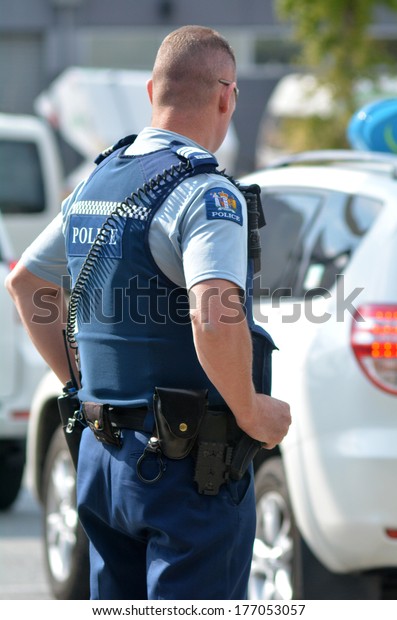 QUEENSTOWN, NZ - JAN 18 2014:NZ Policeman on\
duty. With over 11,000 staff it is the largest law enforcement\
agency in New\
Zealand
