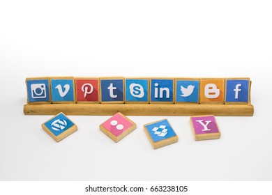QUEENSTOWN, SOUTH AFRICA - 09 APRIL 2017: Social Media logotype popular collection printed and place on wood scrabble game pieces isolated on stand and white background - editorial illustrative image